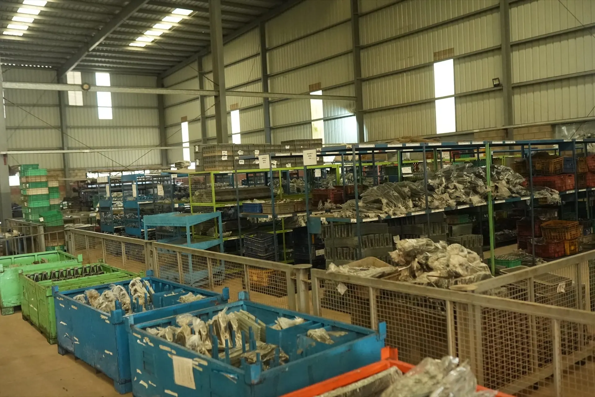 Racks and bins of bagged, finished parts in the storage hall