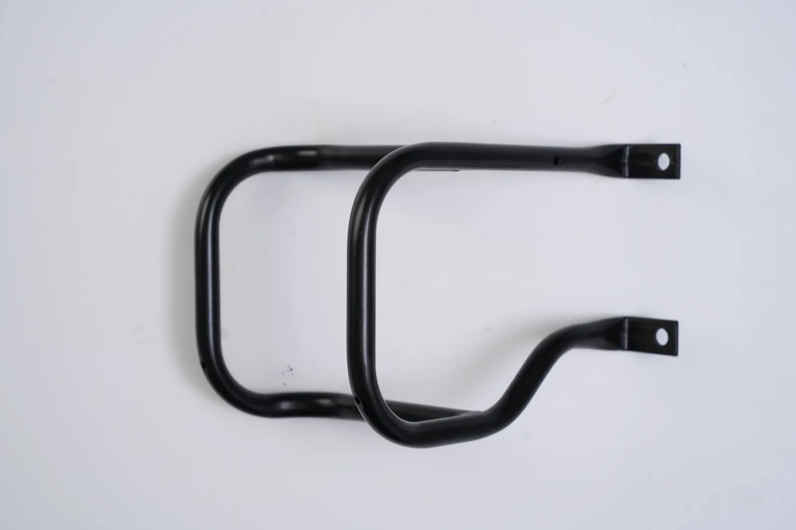 Black double-loop tube frame with flattened, pierced mounting ends