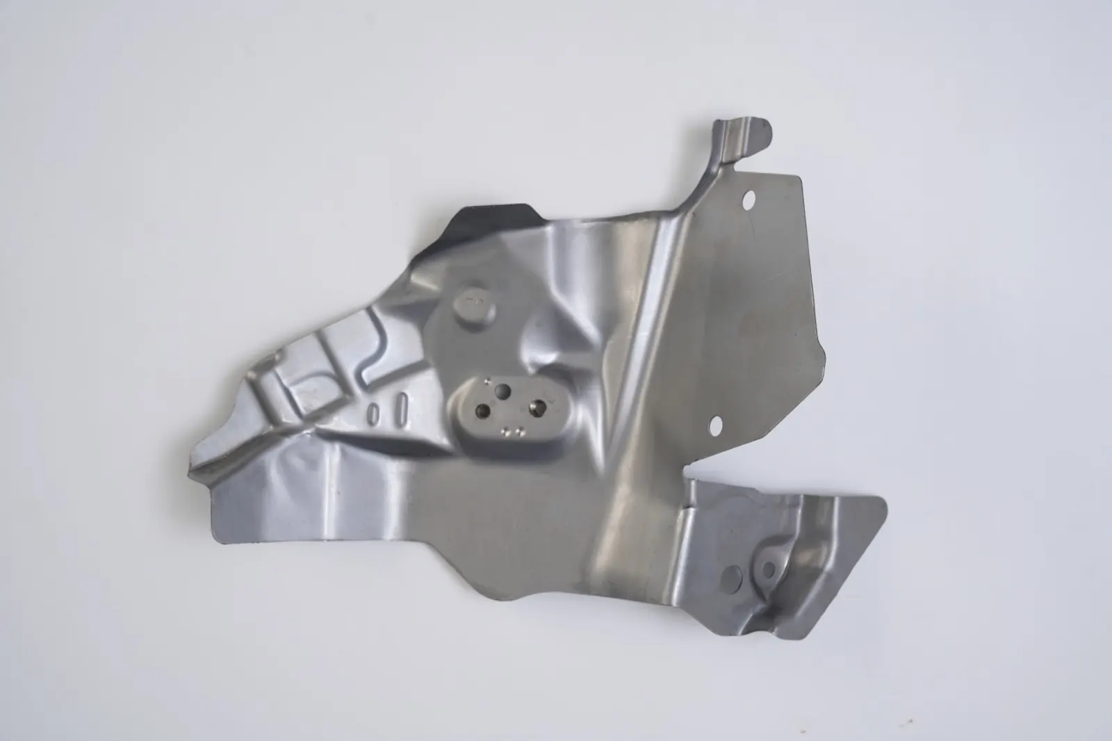 Deep-formed shield bracket with embossed ribs, reverse side